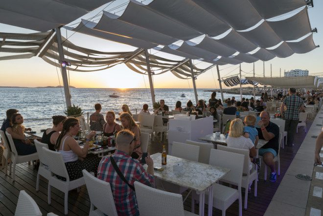 SAN ANTONI DE PORTMANY, IBIZA - MAY 15, 2015: People meet in bars coast to see the famous sunset and fun